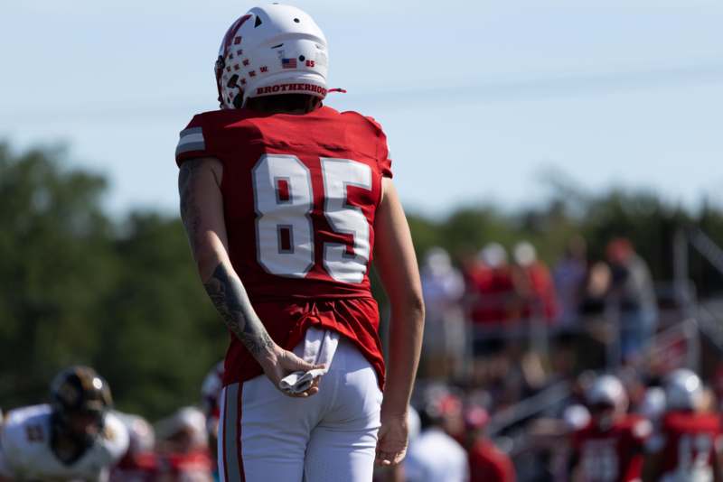 a football player in a red uniform