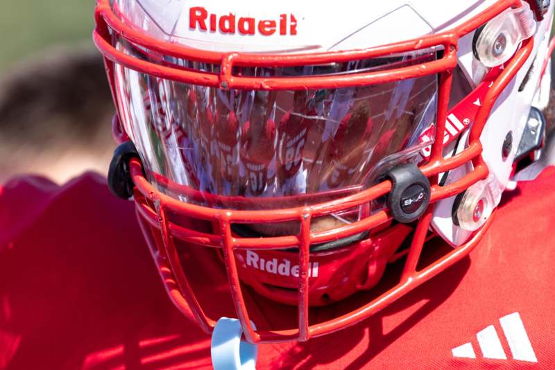 a football helmet with a red face mask