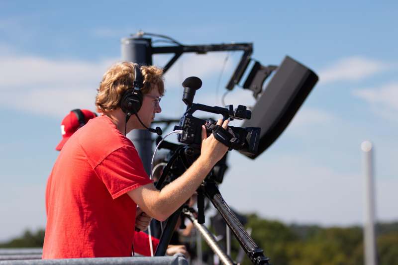 a man with headphones and a camera