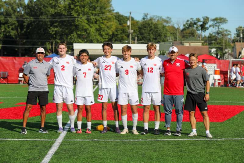 a group of men in sports uniforms on a field
