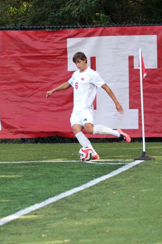 a man kicking a football ball