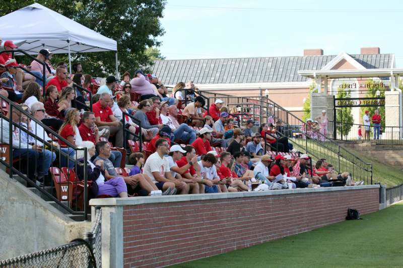 a crowd of people sitting in bleachers