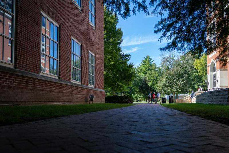 a brick walkway with people walking on it