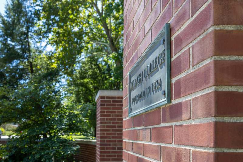 a sign on a brick wall