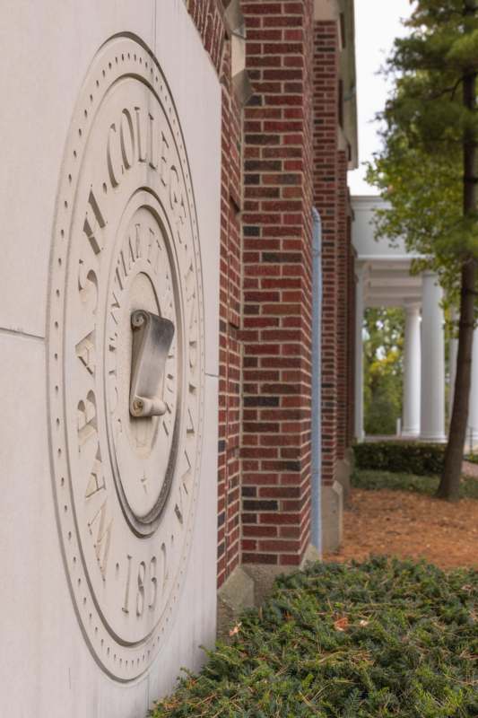 a stone wall with a clock on it
