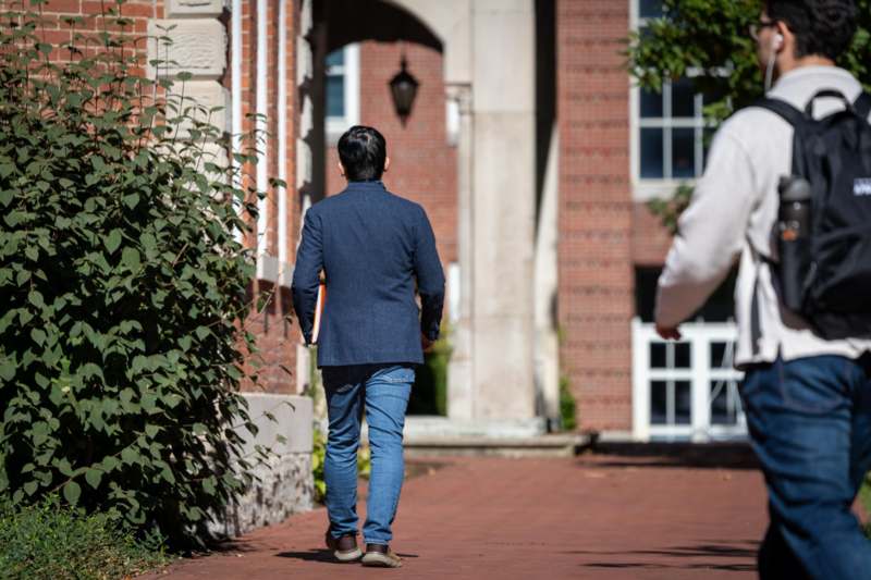 a man walking down a brick walkway