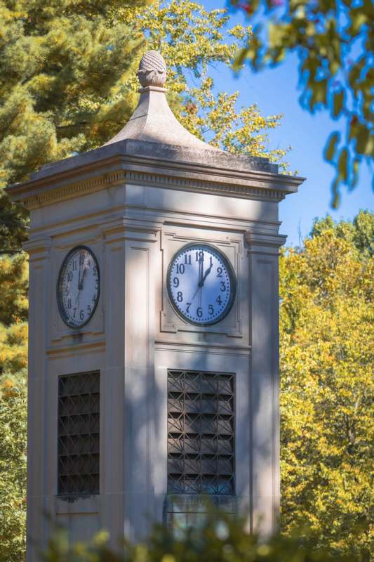 a clock tower with a cross on top