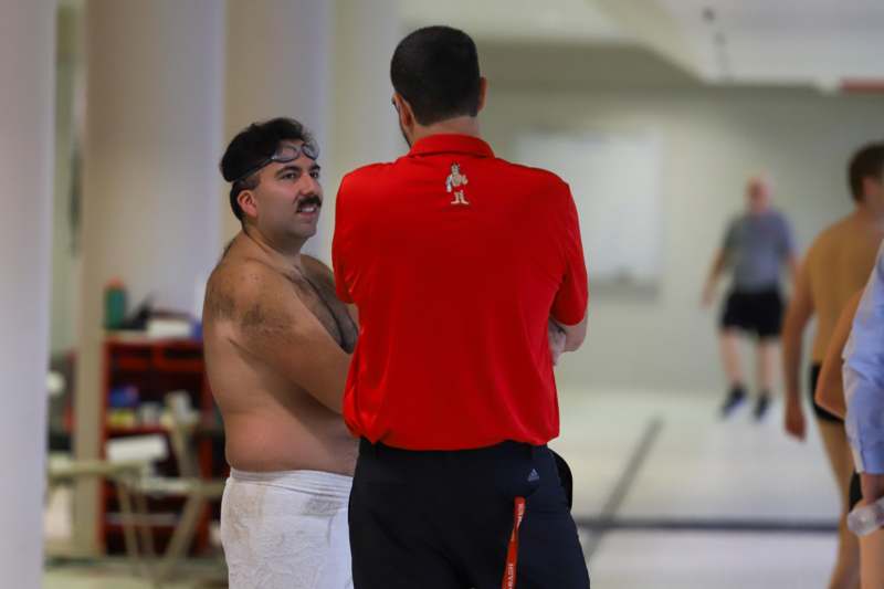 a man standing next to another man