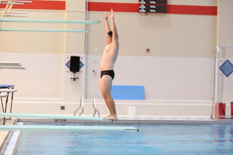 a man standing on a diving board