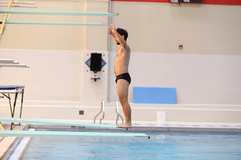 a man standing on a diving board