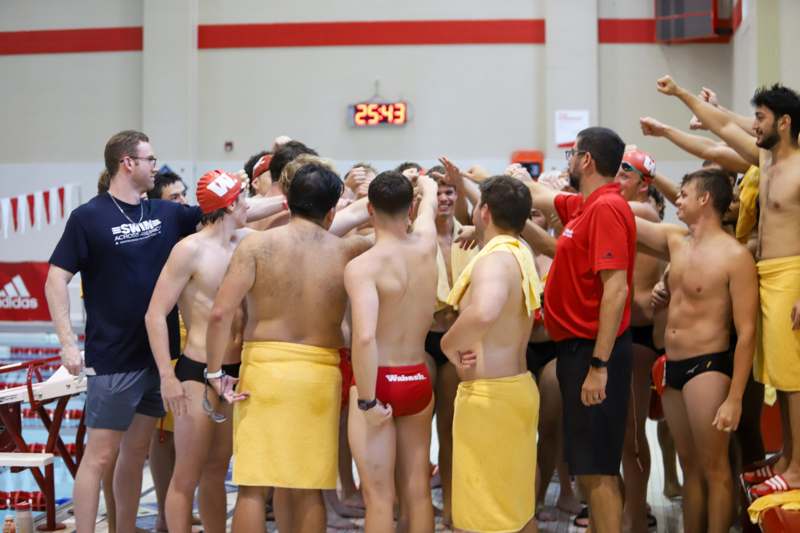 a group of people in swim trunks