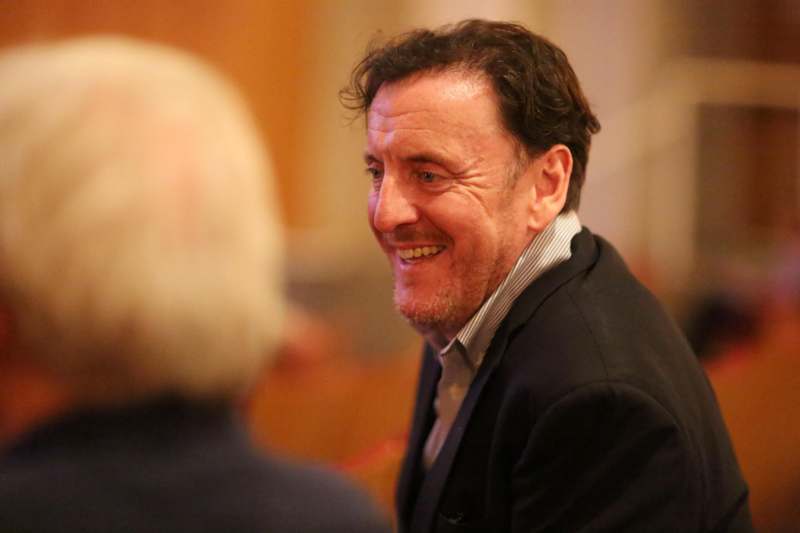 a man in a suit smiling