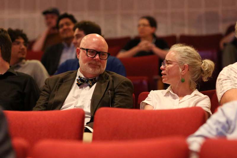 a man and woman sitting in a theater