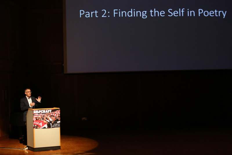 a woman standing in front of a screen