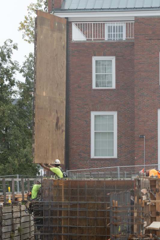 a man lifting a large piece of wood