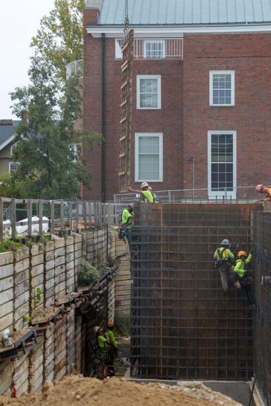 a group of men in safety vests working on a construction site
