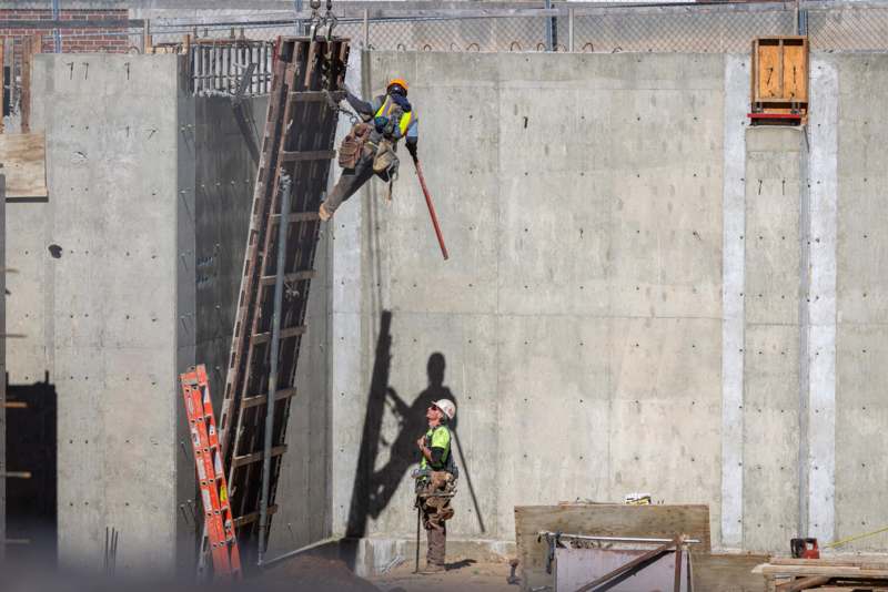 Community Center Construction - a man climbing a ladder