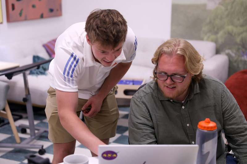 a man looking at a laptop
