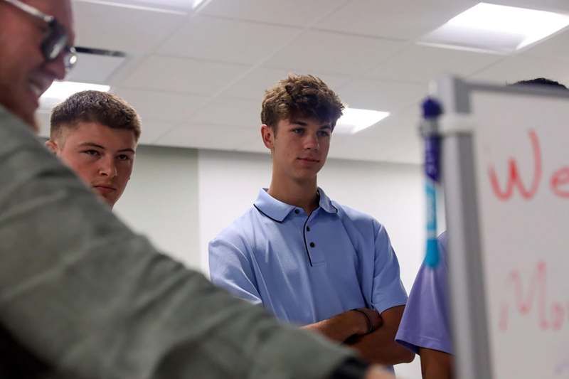 a group of young men standing in a room