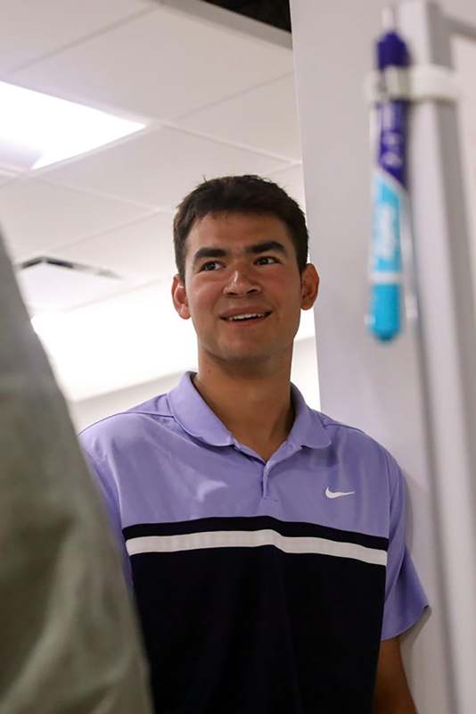a man in a purple shirt