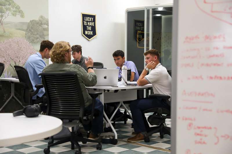 a group of people sitting around a table