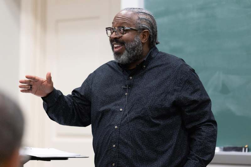 a man in glasses and a black shirt
