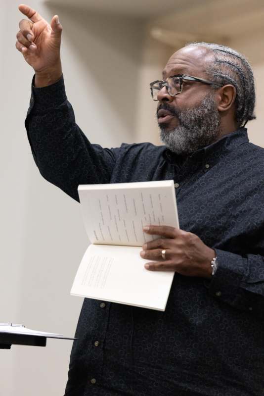 a man holding a book and pointing