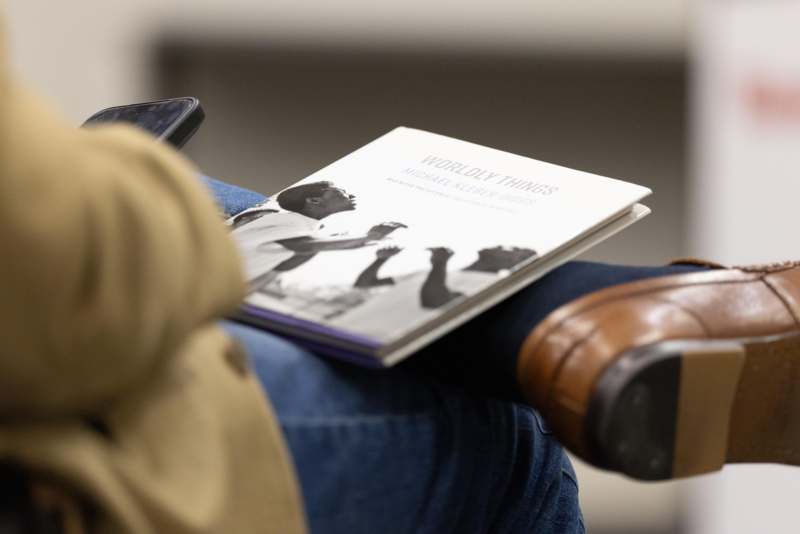 a person sitting in a chair with a book on their lap