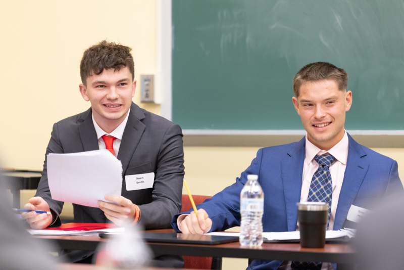 a group of men sitting at a table