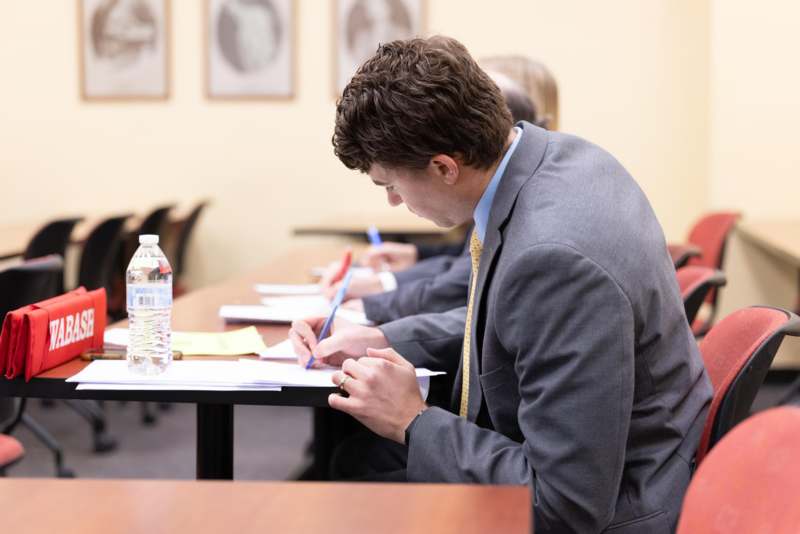a man writing on paper