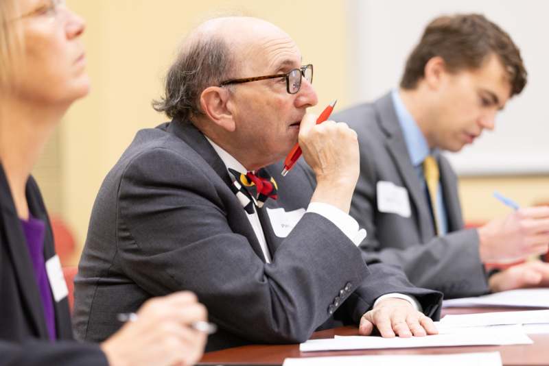 a man in a suit holding a pen