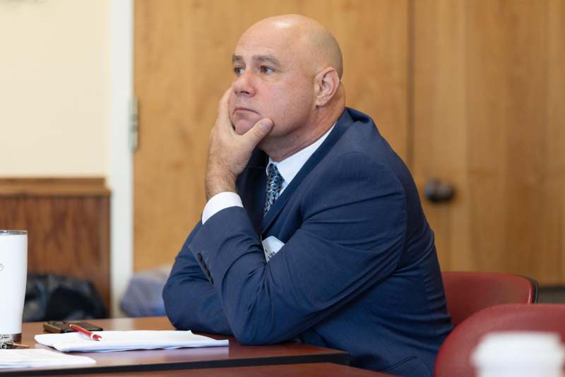 a man in a suit sitting at a desk