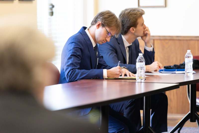 a group of men sitting at a table