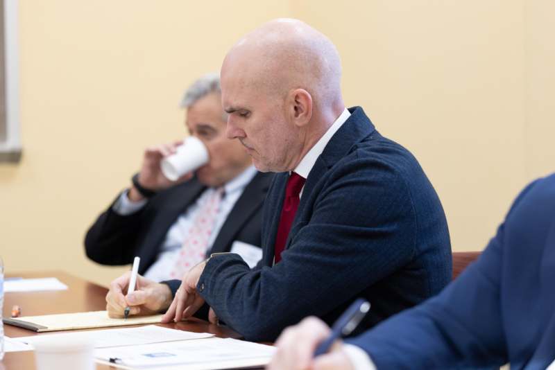 a group of men sitting at a table