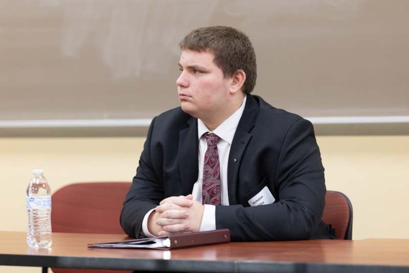a man in a suit sitting at a table