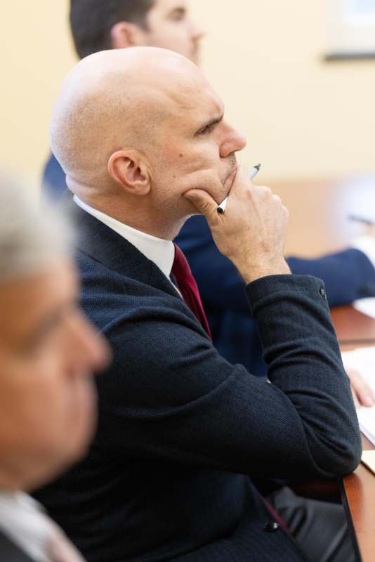 a man in a suit holding a pen in his hand