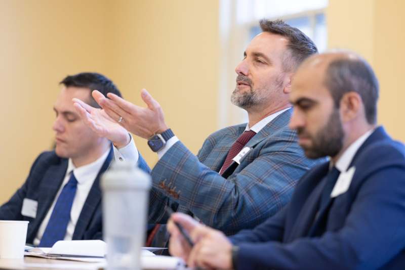 a group of men in suits clapping