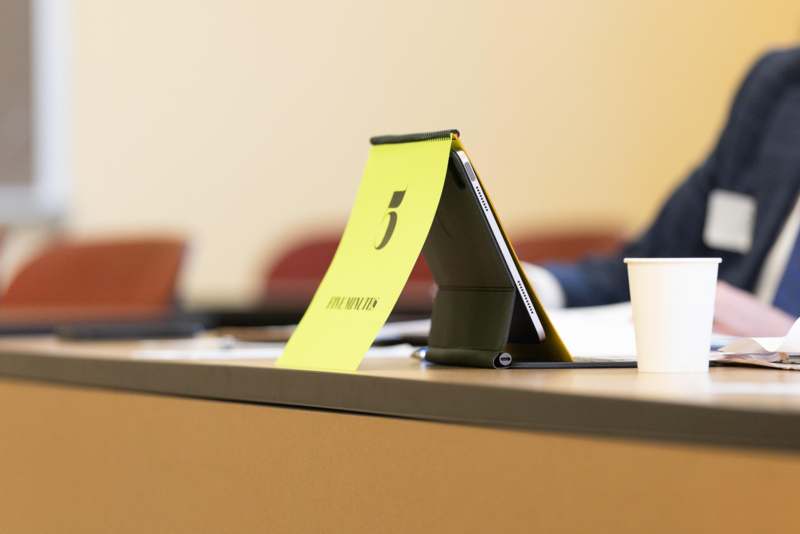 a tablet with a yellow paper on it