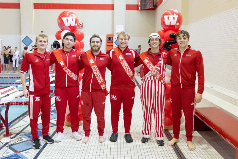 a group of men in red and white outfits posing for a photo