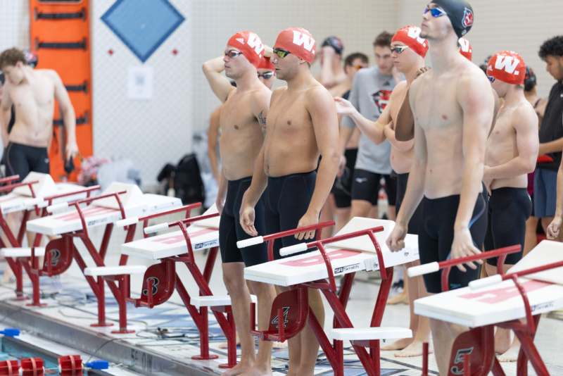 a group of swimmers standing next to each other
