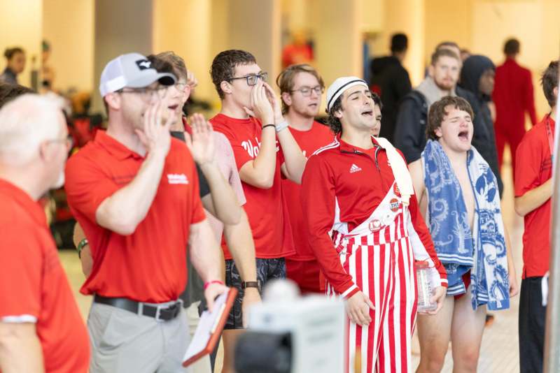a group of people in red shirts