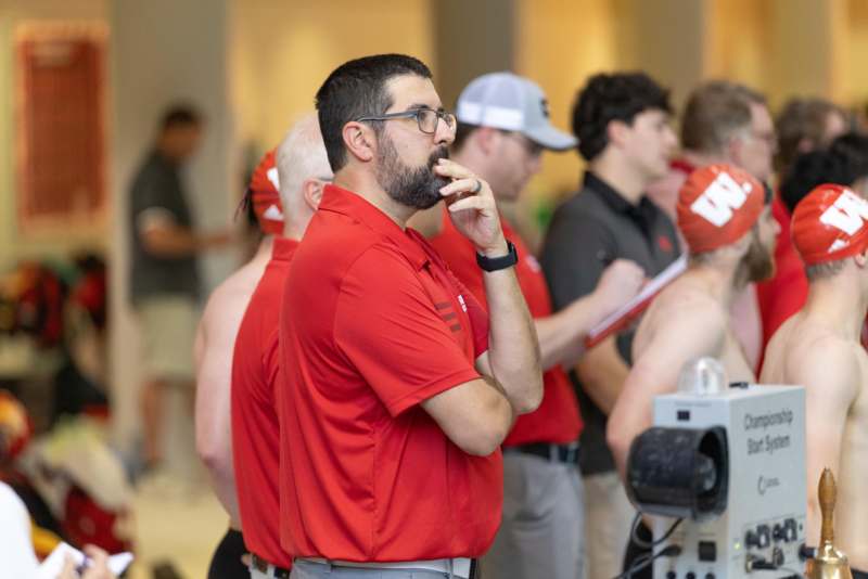 a man in red shirt smoking a cigarette