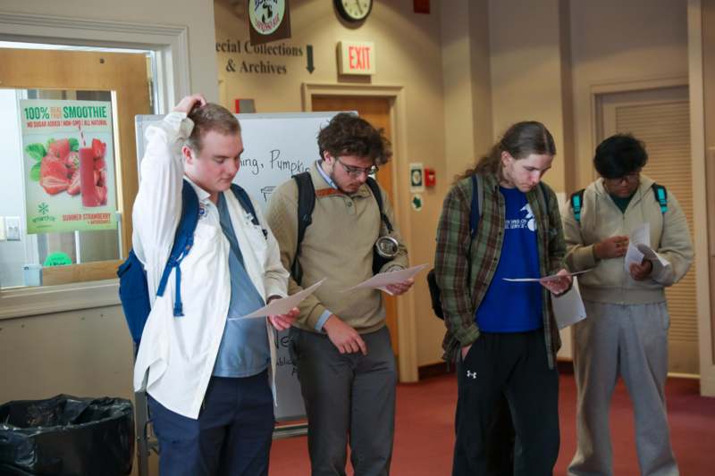 a group of people standing in a hallway