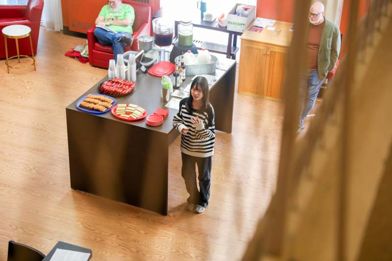 a girl standing in front of a counter with food on it