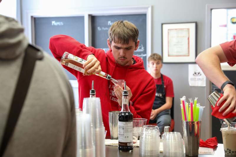 a man pouring alcohol into a glass