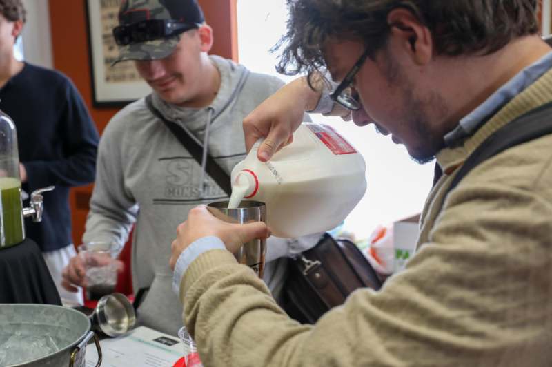 a man pouring milk into a cup