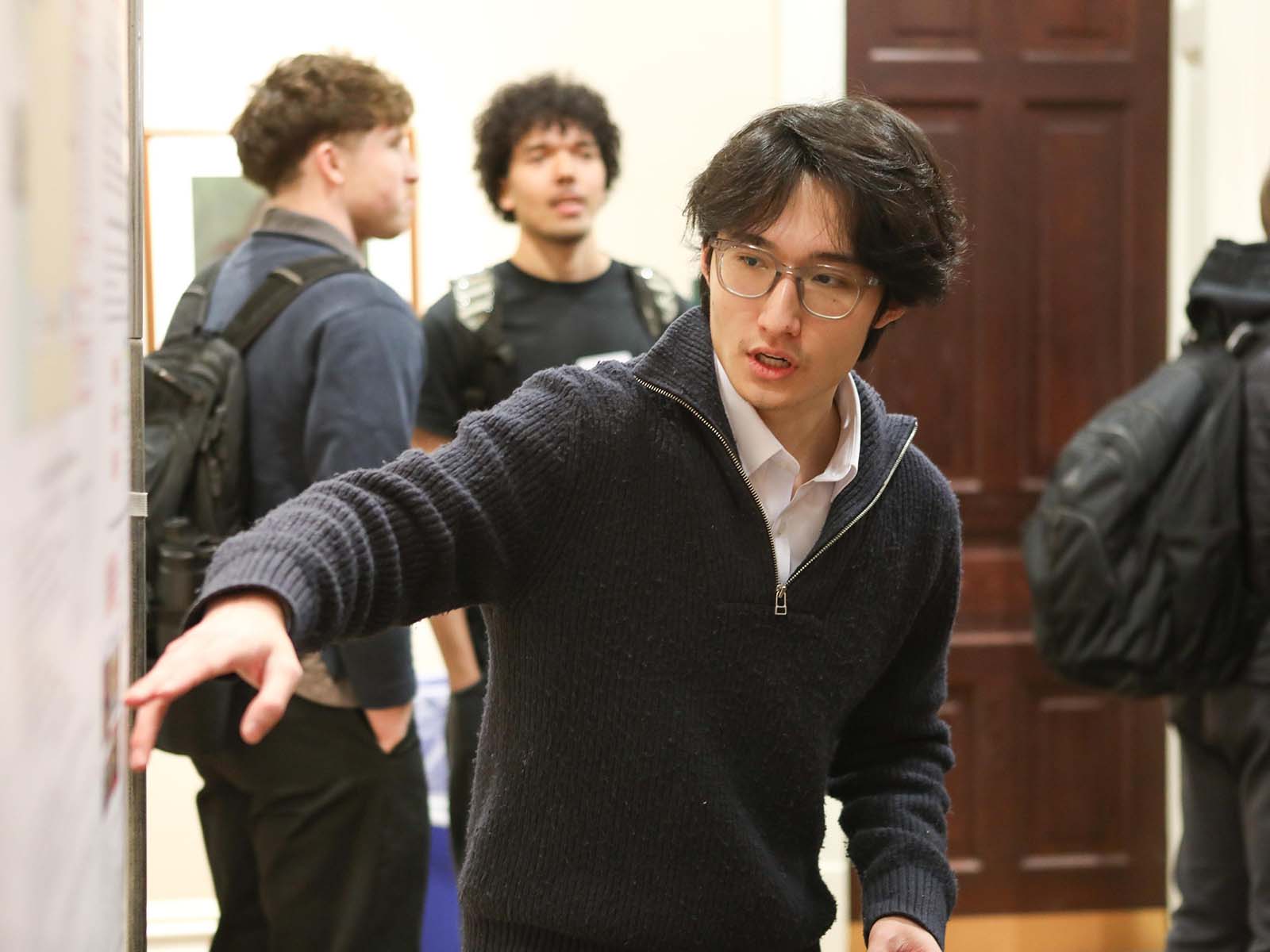 a person in a black sweater giving a presentation