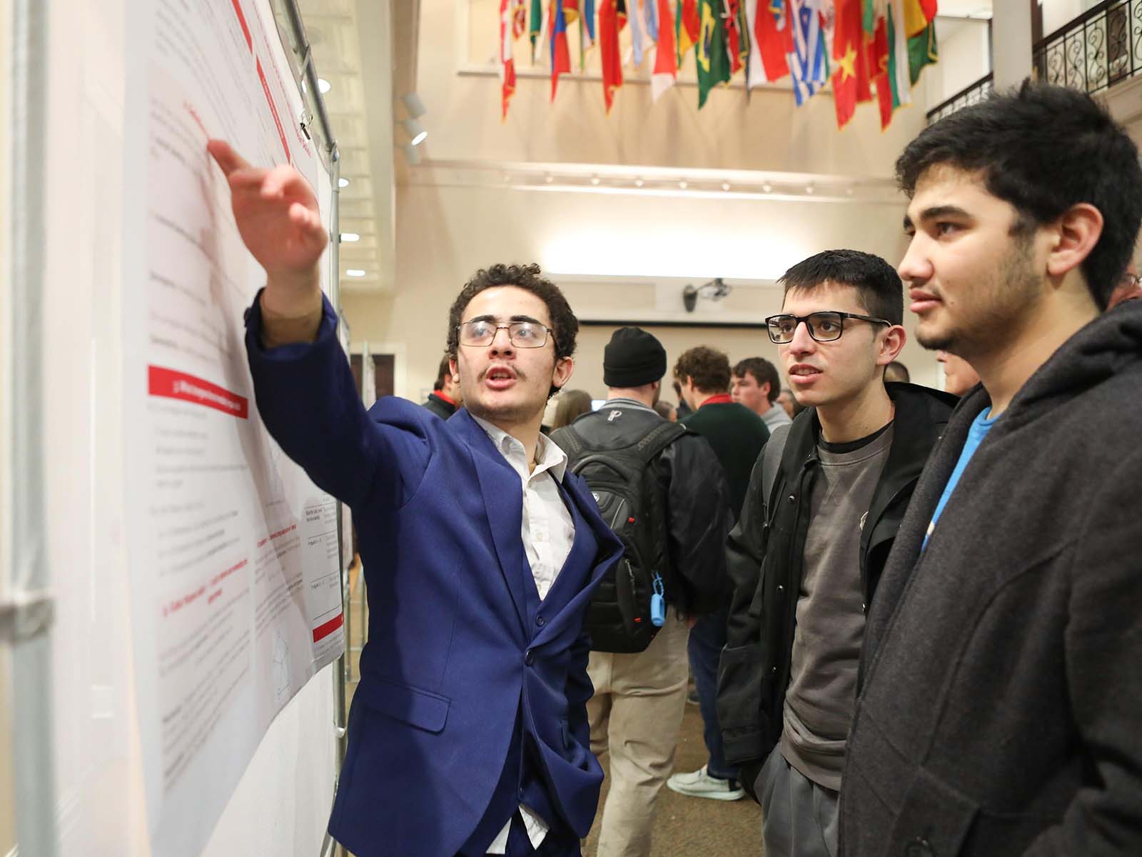 a person pointing at a poster